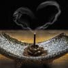 Incense in a burner with heart-shaped smoke